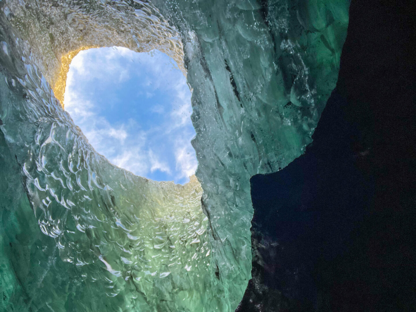 A view of the sky through a hole in a cave.