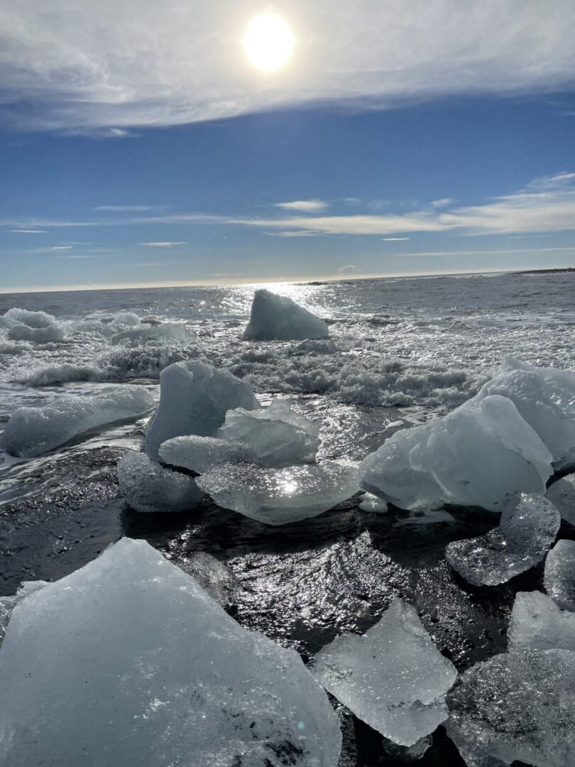 A group of ice blocks floating on top of the ocean.