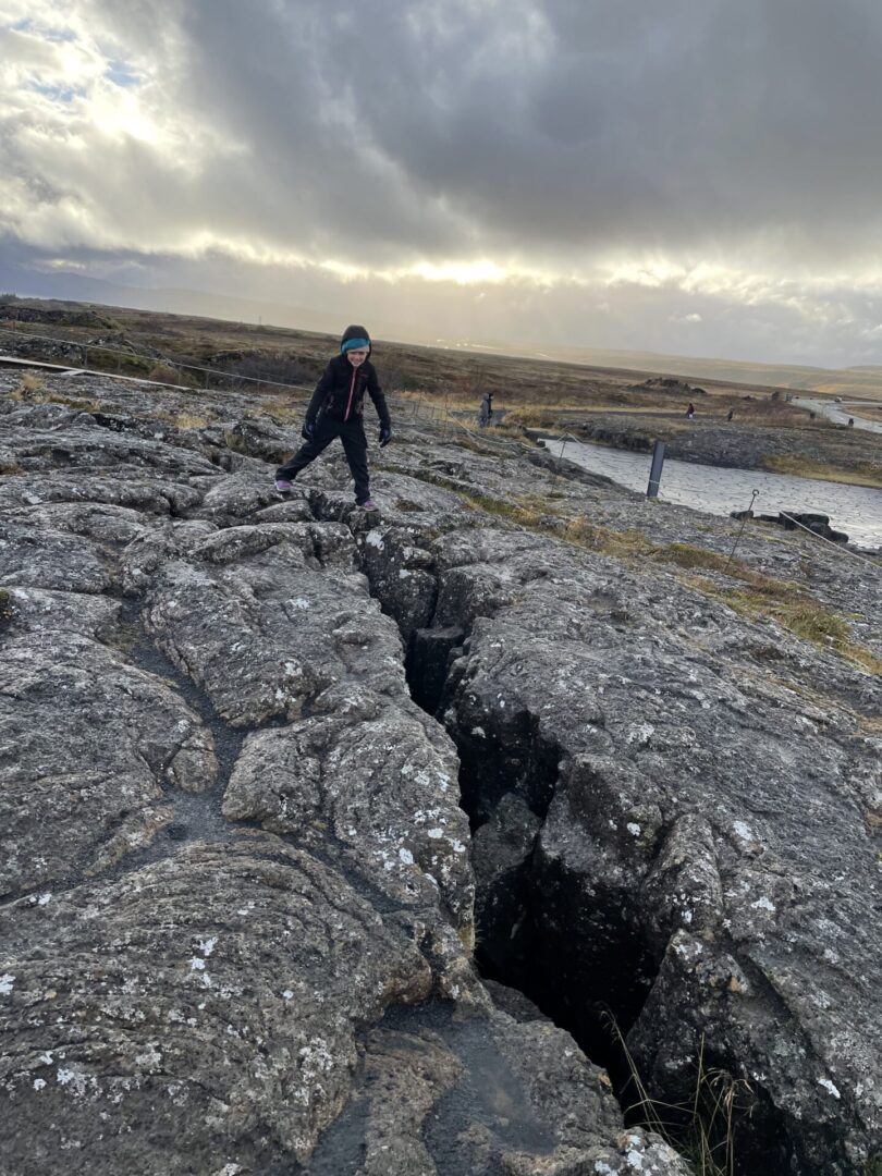 A person standing on top of a rock formation.