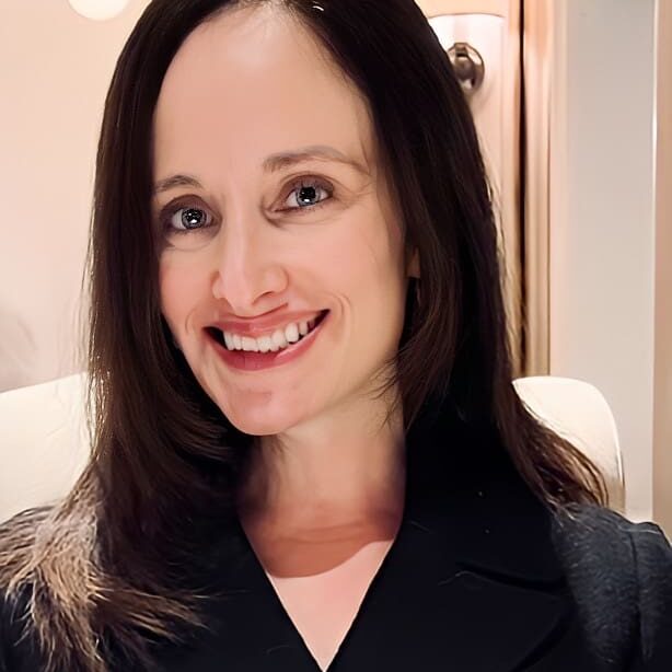 A woman with long hair and a black shirt.